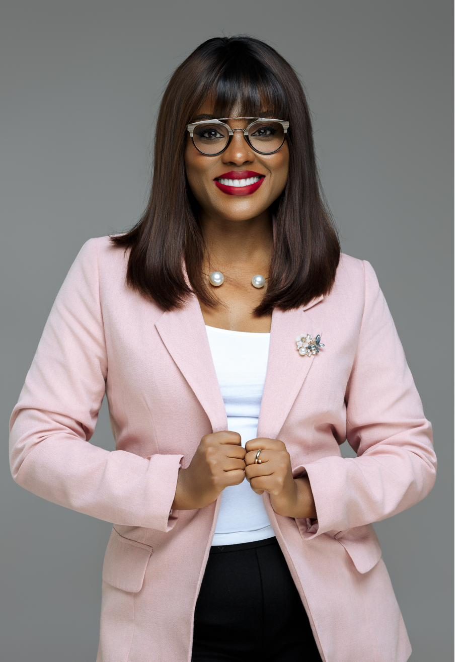 Abidha Din in a studio portrait, founder of Impakt Wealth Partners